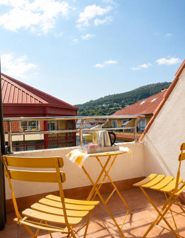 a balcony with a table and two chairs on a balcony at Airtegal Atico Mar de Cedeira in Cedeira