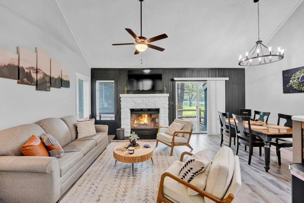 a living room with a couch and a fireplace at The Pocono Loft in Lake Harmony