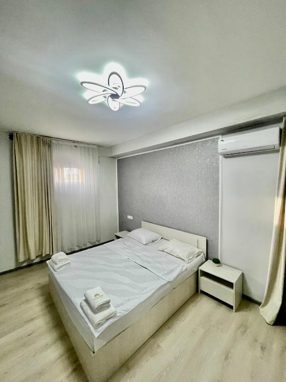 a bedroom with a bed and a ceiling fan at Hayq in Yerevan