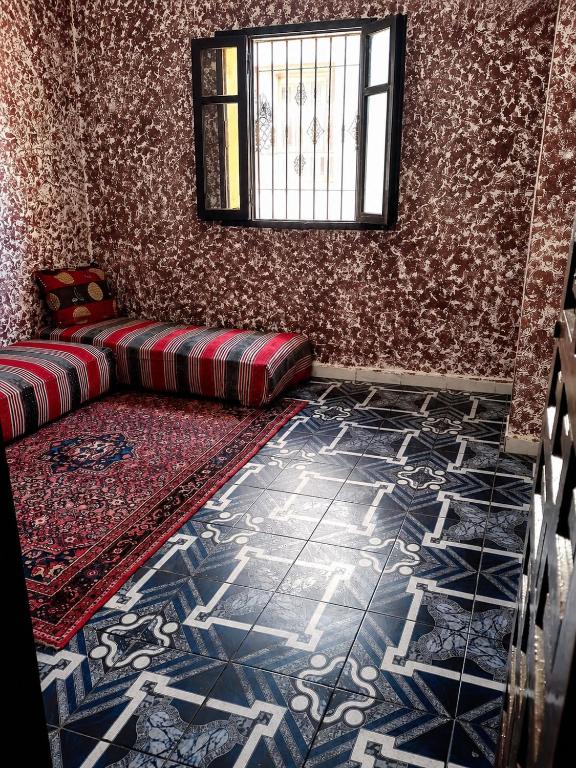 a room with a couch and a rug on the floor at Marchica House in Nador