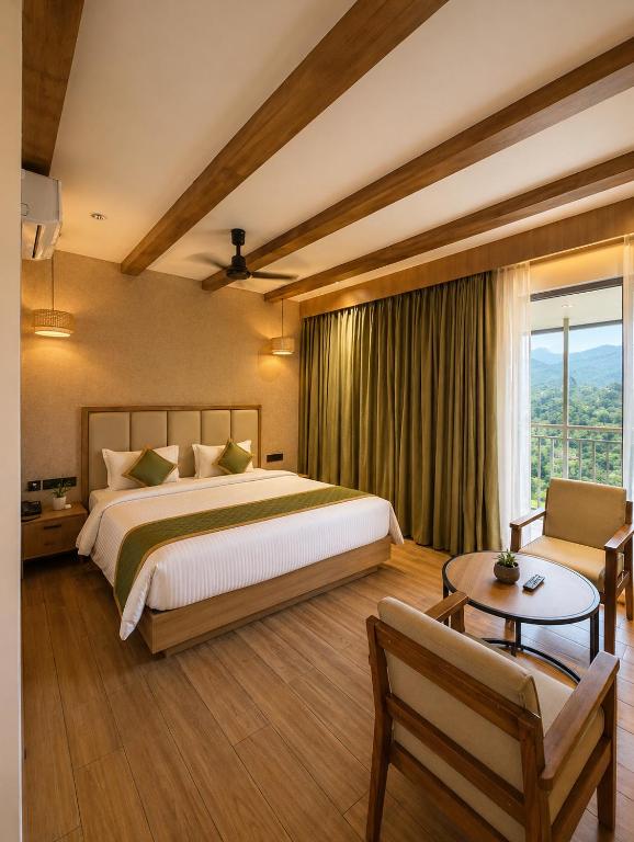 a large bedroom with a large bed and a table at The Signature Munnar in Munnar