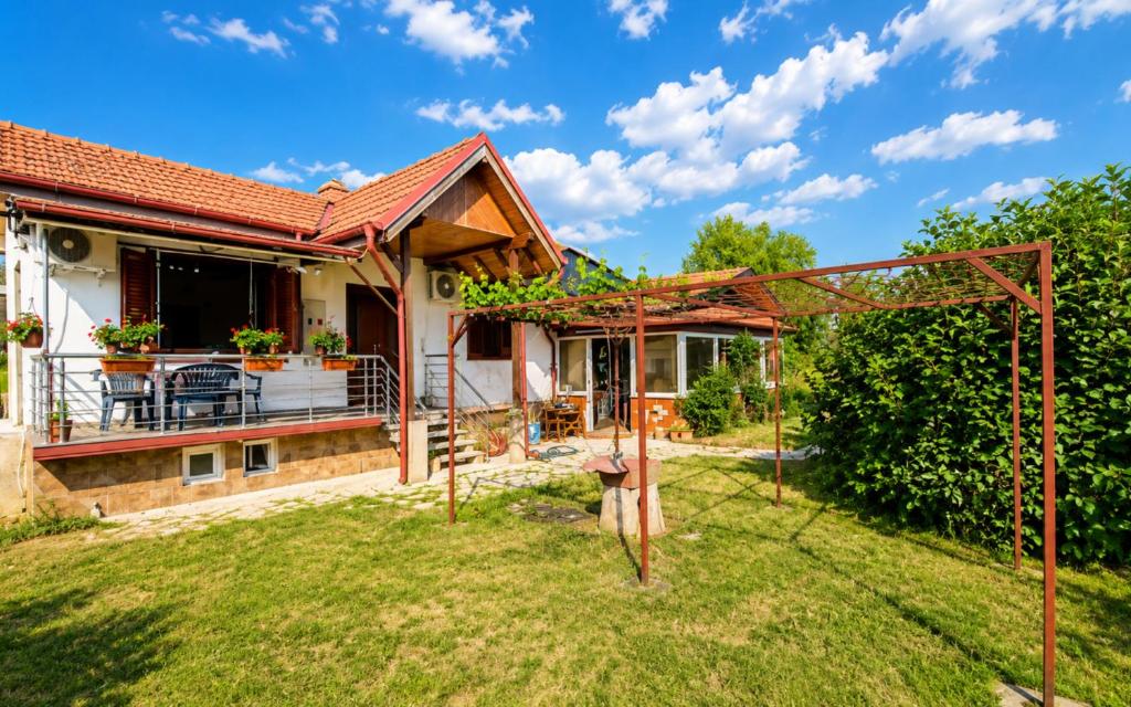 a backyard with a house and a pergola at Villa Indigo in Berovo