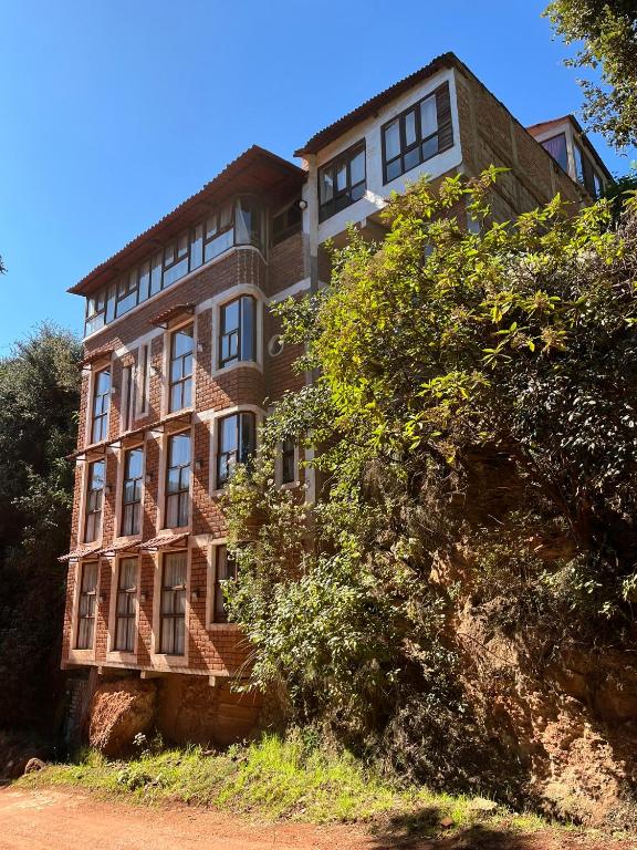 a large brick building on top of a hill at La Misión Hotel Chignahuapan in Chignahuapan