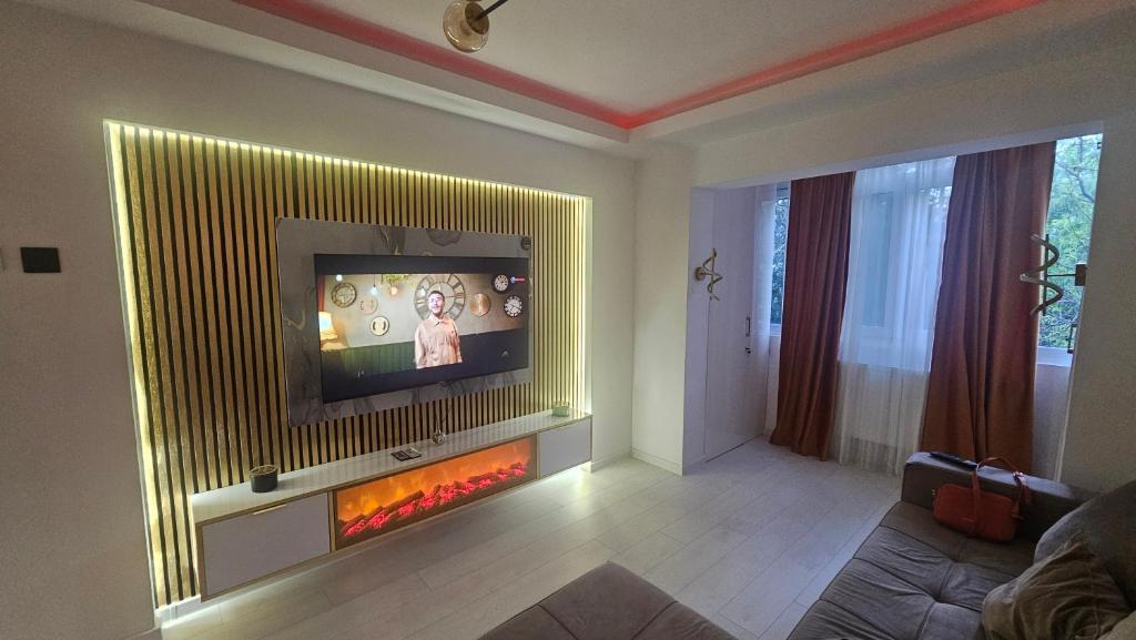 a living room with a tv and a fire place at DNY Home 2 in Giurgiu