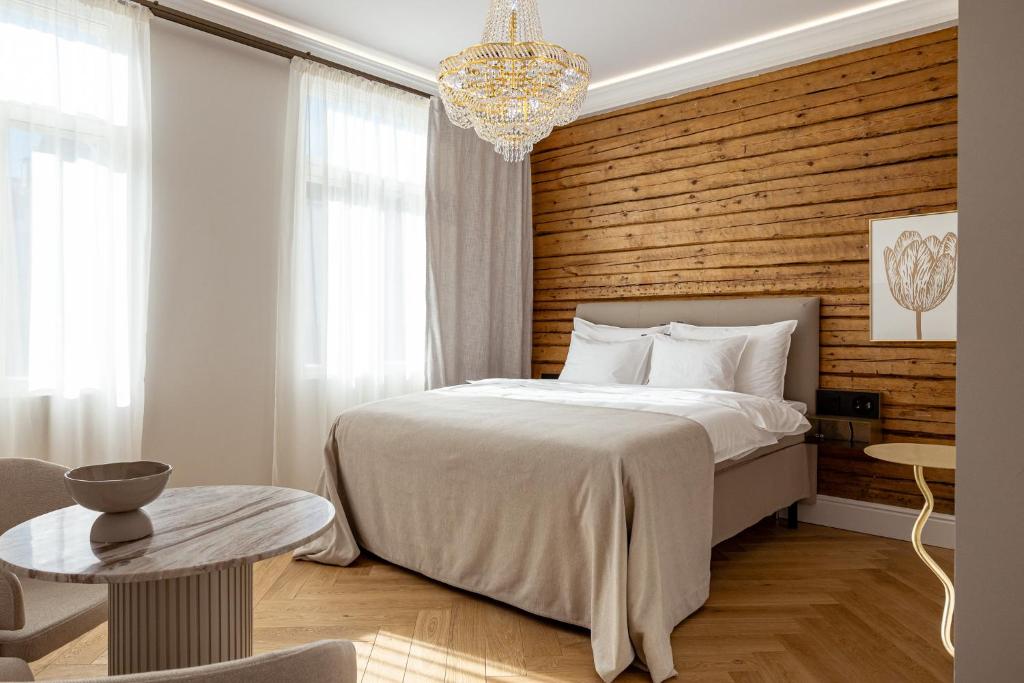 a bedroom with a bed and a wooden wall at Sugar Factory Apartments in Kotka