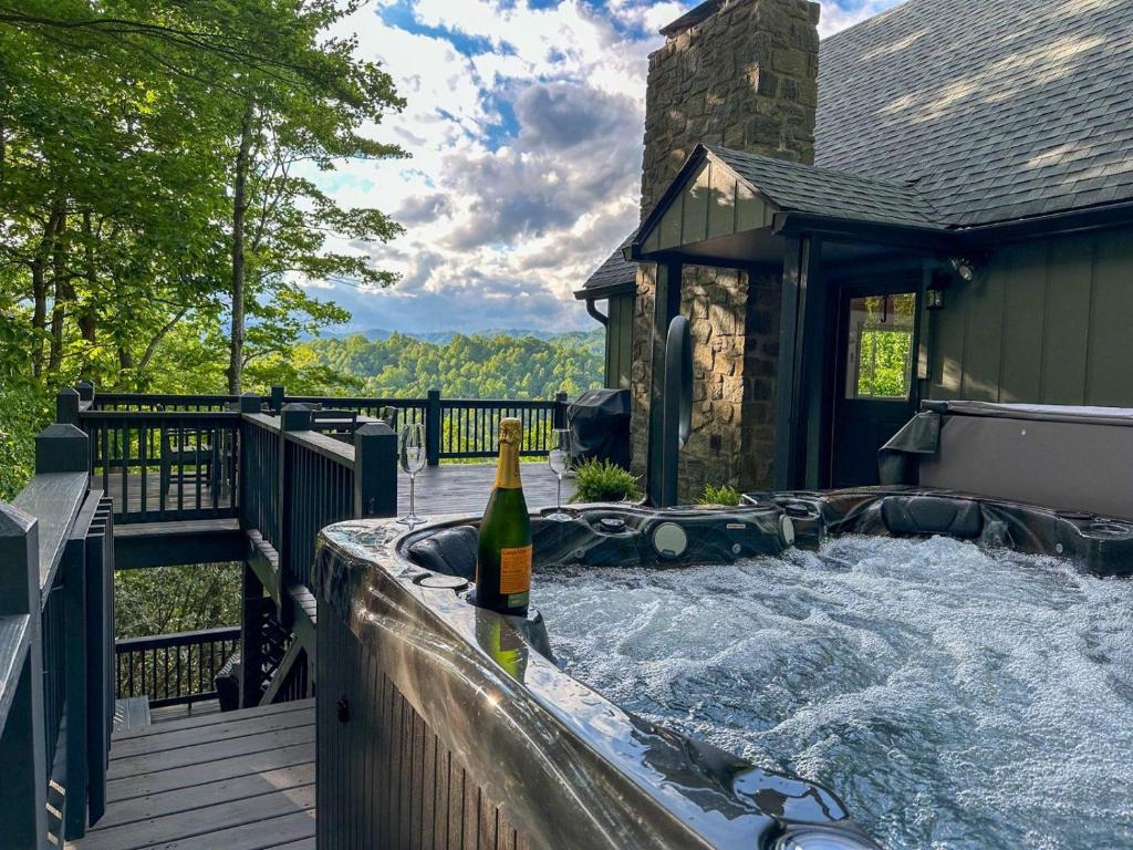 a bottle of wine sitting on a hot tub on a deck at Star View Cabin - Powder Horn Mountain in Powderhorn Mountain