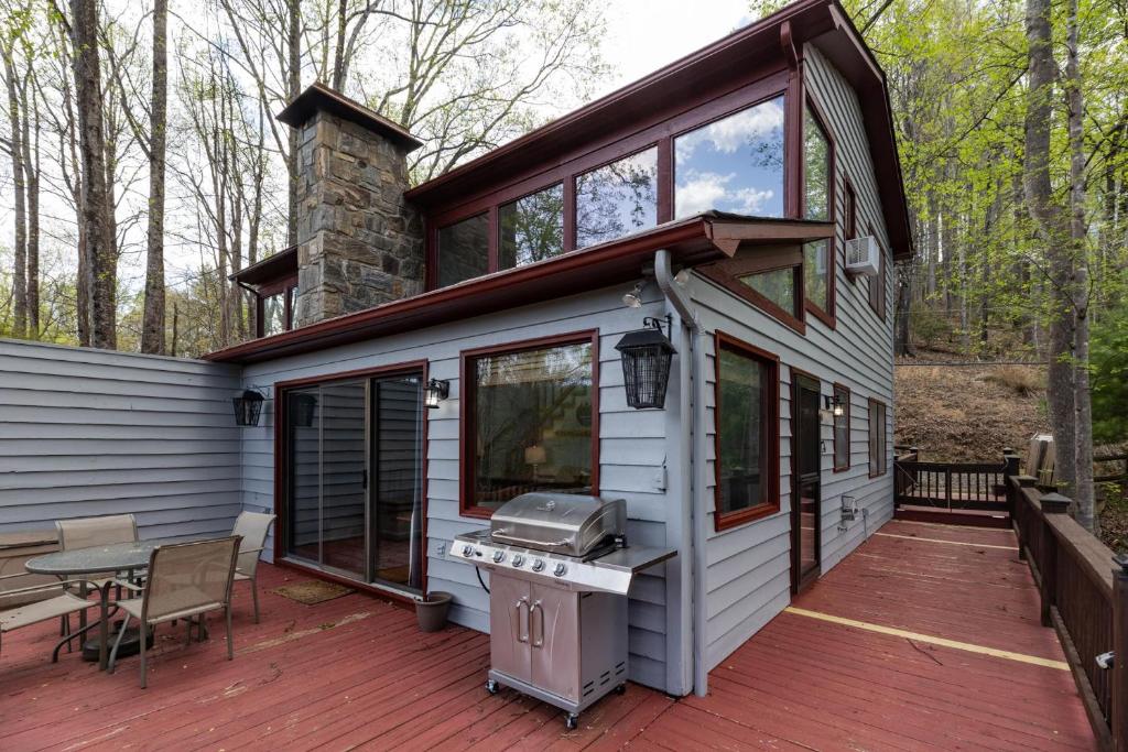 a house with a grill on a deck at Eagle Point - Powder Horn Mountain in Powderhorn Mountain