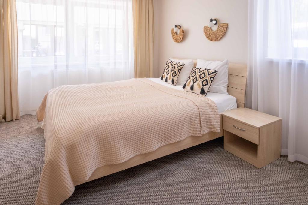 a bedroom with a bed with a white comforter at Freda Self Check-in in Nida