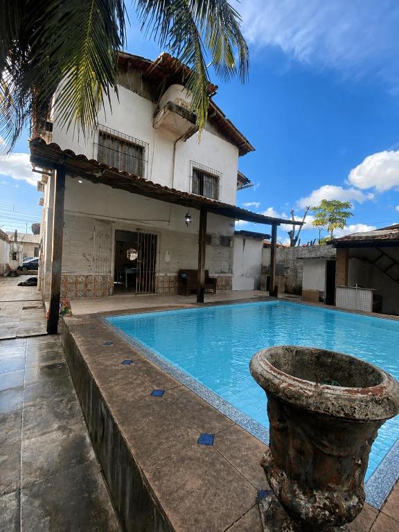 a swimming pool in front of a house at Casa Salinas em Salinópolis PA - Completa in Salinópolis