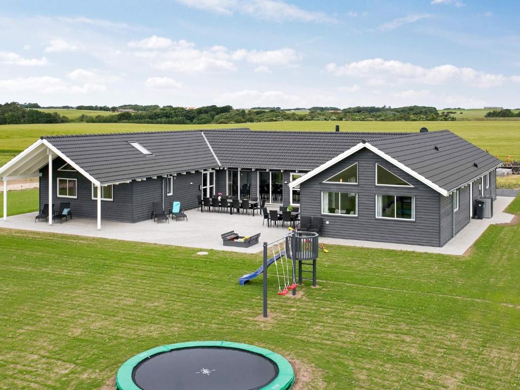 a house with a playground in front of it at 5 star holiday home in Spøttrup in Spottrup