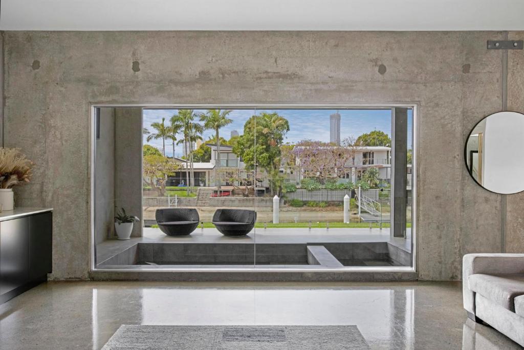 a living room with a large window with two chairs at Urban Hideaway - Stay 4 Pay 3 in Gold Coast
