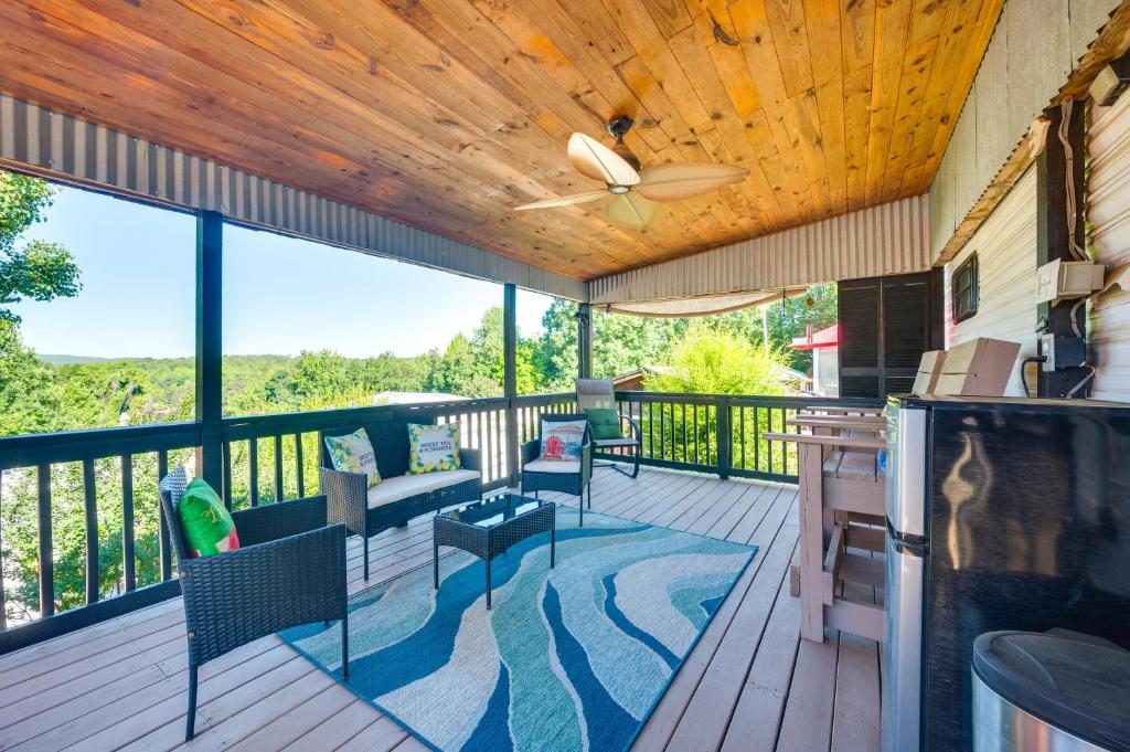 a screened in porch with a ceiling fan and chairs at Pool & Dock Access! Badin Lake Resort Gem in New London