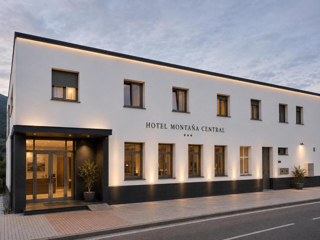 a white building with the words hotel workshop central at Hotel Montaña Central in Caborana