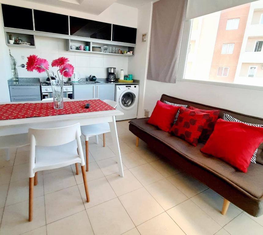 a living room with a couch and a table with red pillows at Dptos CipoTerra in Cipolletti
