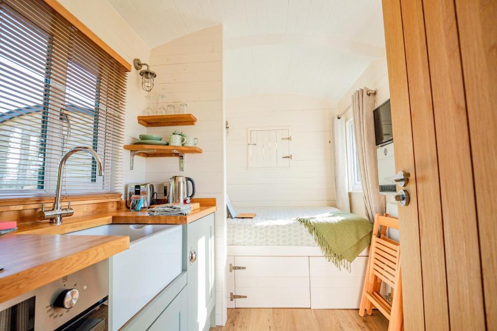 a kitchen with a sink and a counter top at Hazel Boutique Shepherds Hut Cotswolds in Cirencester
