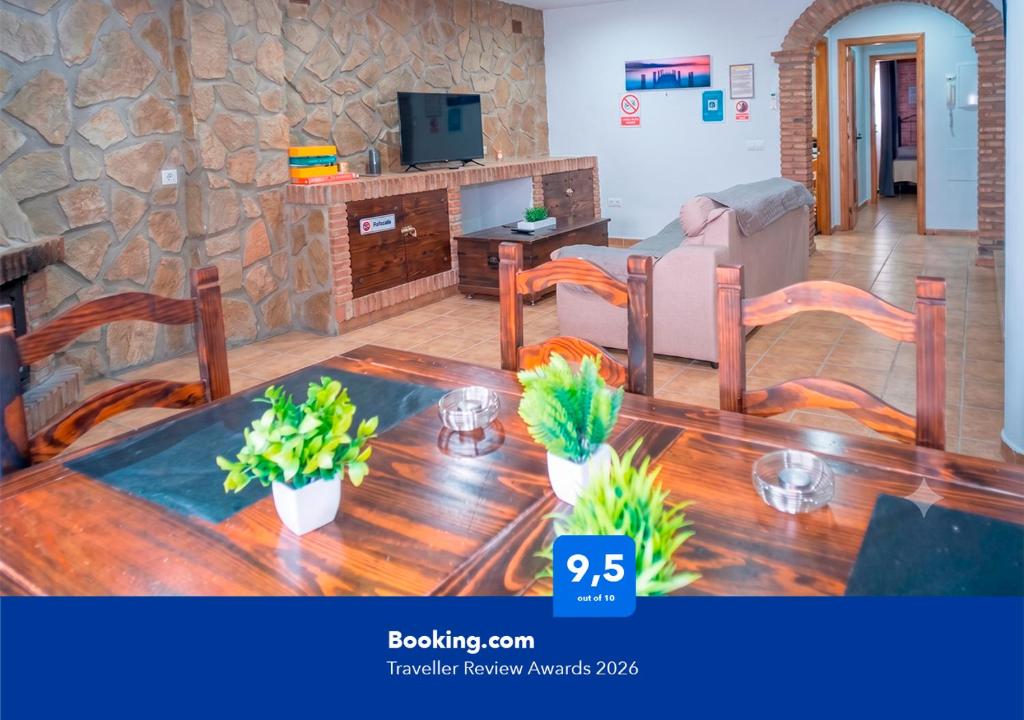 a living room with a wooden table and chairs at Apartalux Aqua Magic in Barbate
