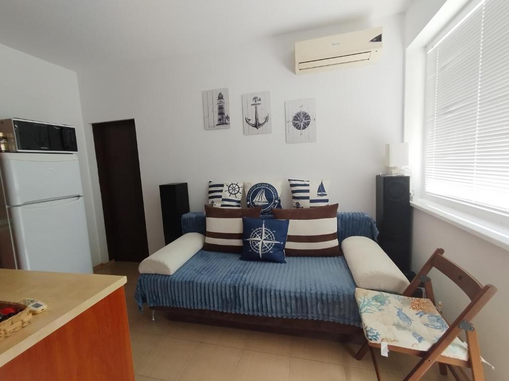 a living room with a couch with pillows on it at SEA SKY View in Byala