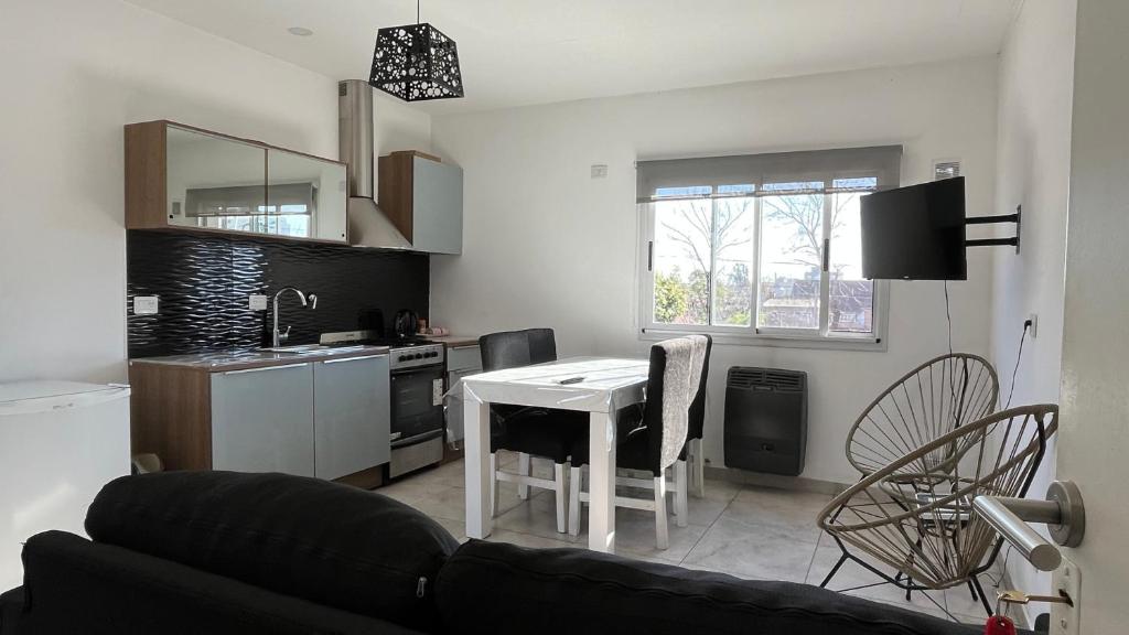 a living room with a couch and a table in a kitchen at Travel Suites Ezeiza- 5 pax- Centro Eze- Shoppings a 8 min in Ezeiza