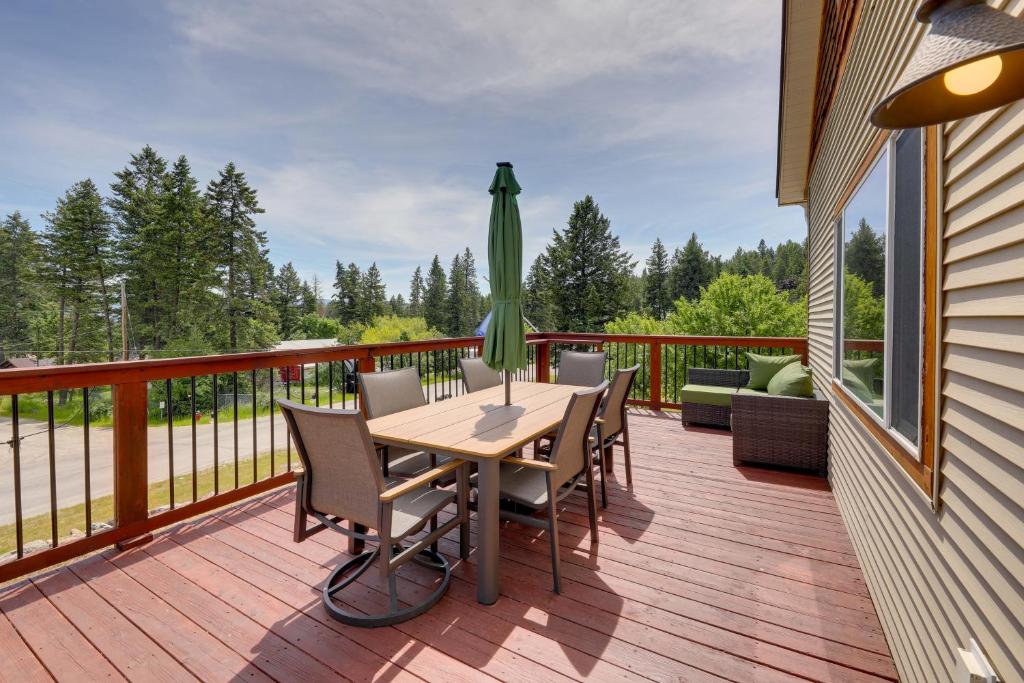 a patio with a table and chairs on a deck at Walk to Flathead Lake! Home w/ Deck & Fenced Yard! in Lakeside