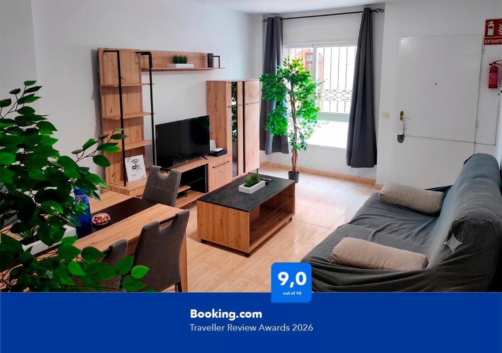 a living room with a couch and a tv at Apartalux Aura Essence in Garrucha