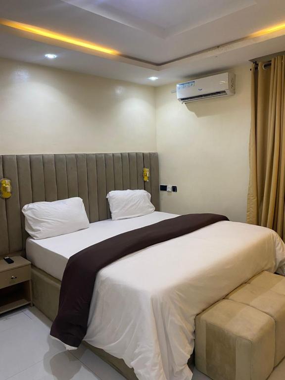 a bedroom with a large bed in a room at CHASE hotels in Ibadan