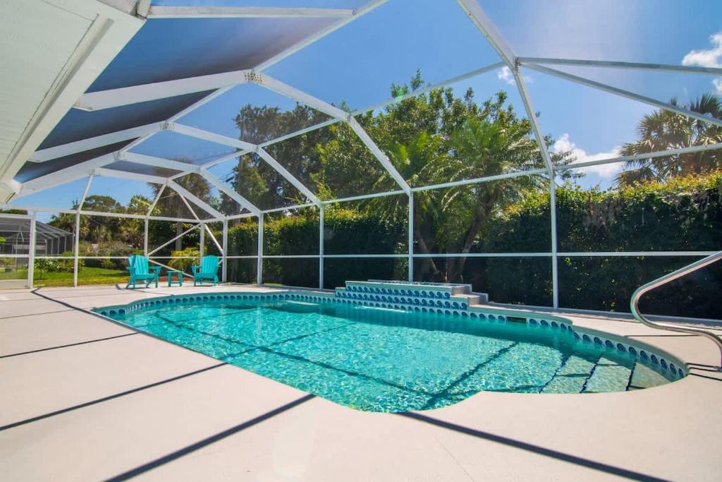a swimming pool in a glass house at Beach Getaway - Pool & 2 King Beds in Sebastian