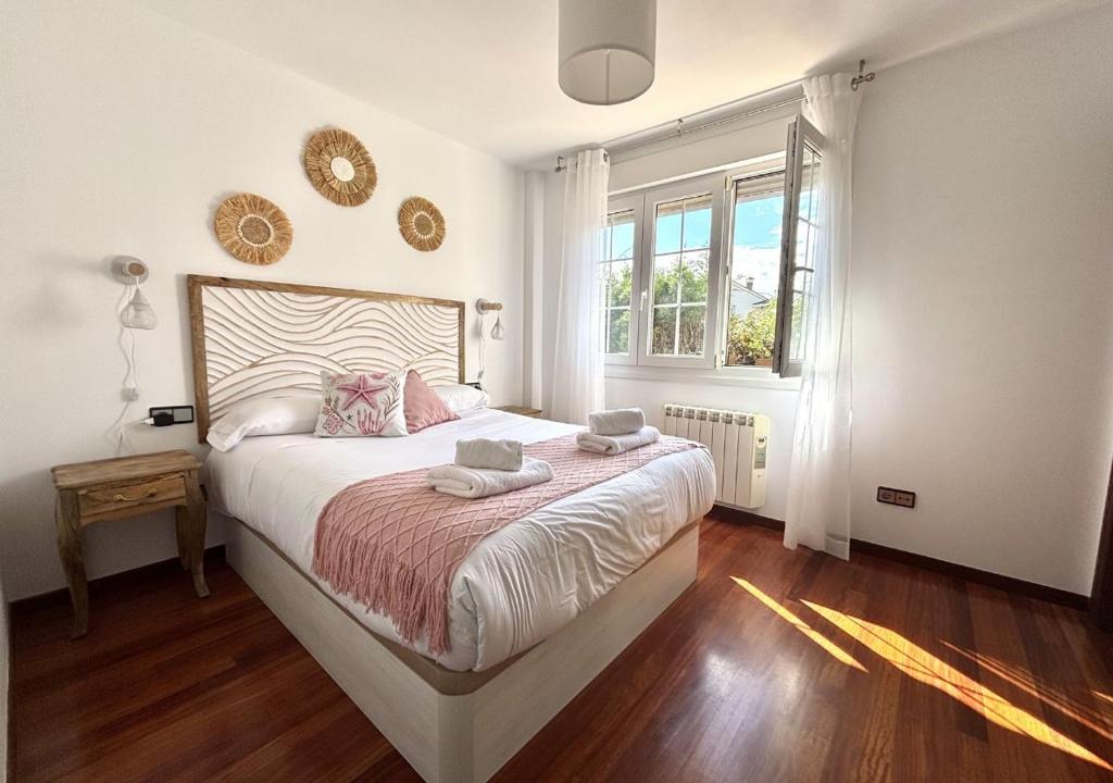 a bedroom with a large bed and a window at Xivares playa in Carrió