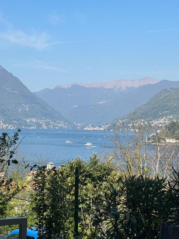 a view of a large body of water with mountains at Panorama Terrace - Como Lake in Como