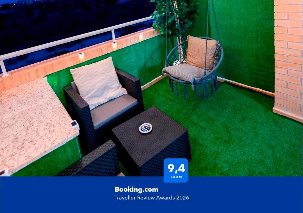 a balcony with a chair and a table and a couch at Apartalux Magic Silver in Oropesa del Mar