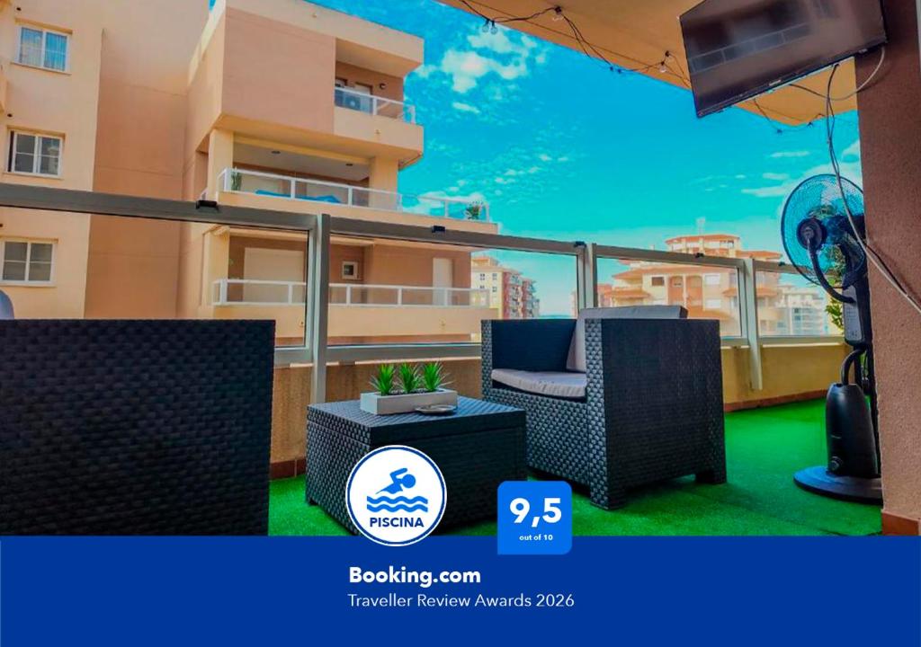 a balcony with a chair and a table and a building at Apartalux Aqua Marina in La Manga del Mar Menor