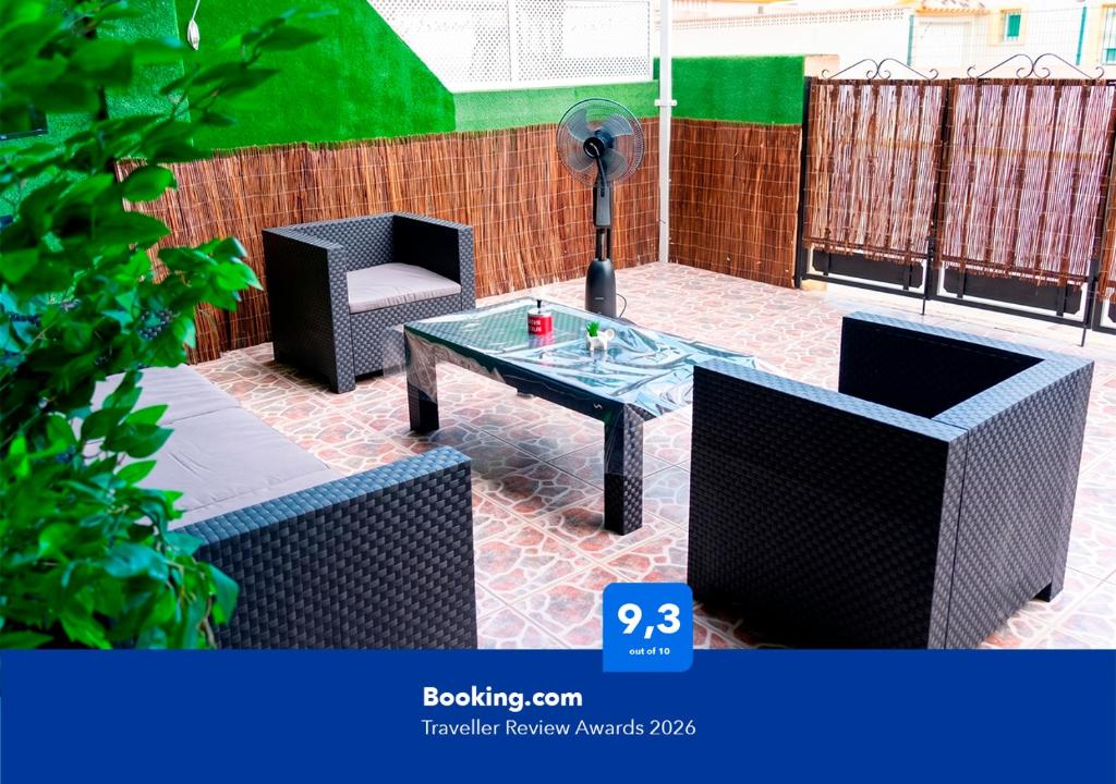 a patio with two chairs and a coffee table at Apartalux Vista Mar in La Manga del Mar Menor