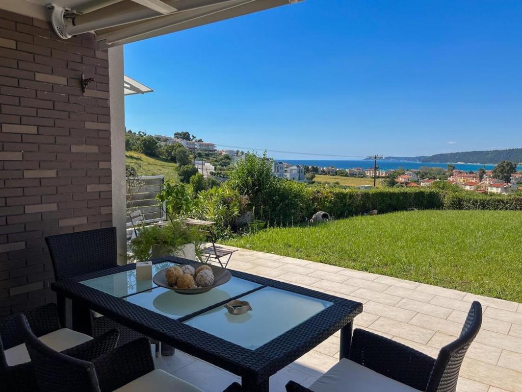 a table with a bowl of fruit on a patio at Boho Mare Retreat - Skala Fourkas in Skala Fourkas