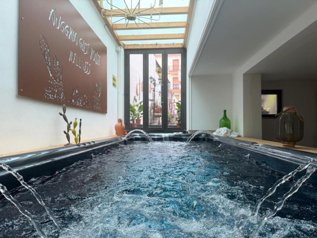 a swimming pool with water coming out of it at A Ugghia- I Mori in Fiumefreddo di Sicilia