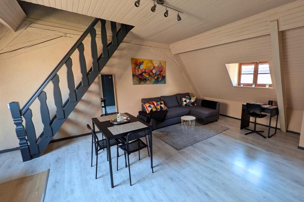 a living room with a couch and a table at Spacious Loft - Quiet and Bright in Soultz-Haut-Rhin
