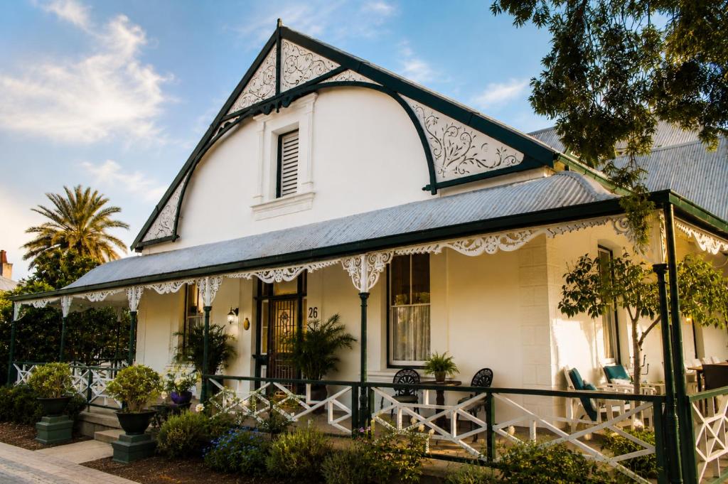 an old white house with a gambrel roof at Albert Manor guest house in Ladismith
