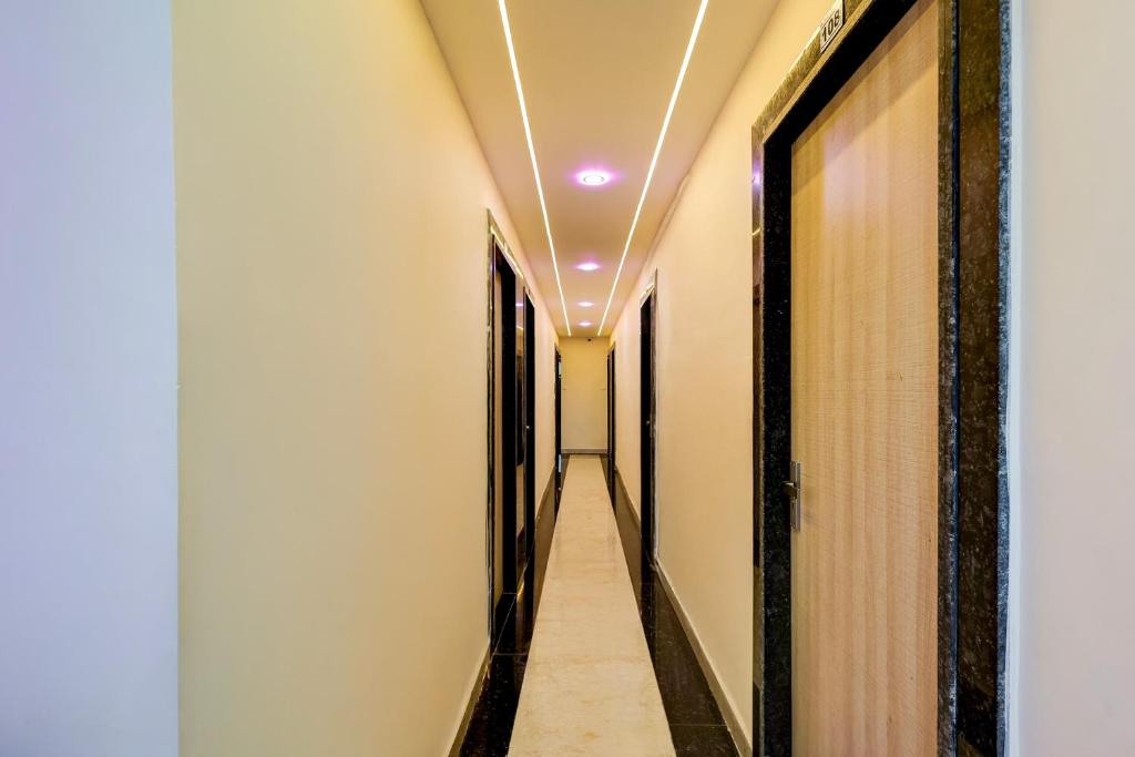 a corridor of a corridor of a building with lights on the ceiling at Hotel O Eleven in Jabalpur