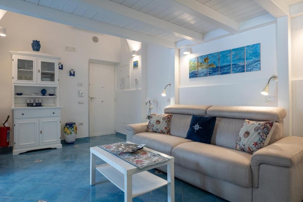 a living room with a couch and a table at Levante - charming apartment with sea-view terrace, fits up to 7 guests in Maiori
