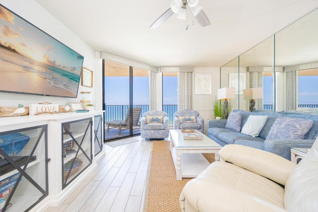 a living room with a couch and a tv at Phoenix V 916 in Orange Beach