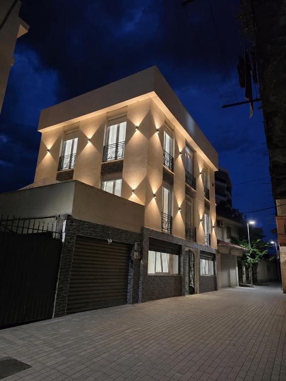 a building with lights on the side of it at night at Vila Gabriel in Shkodër