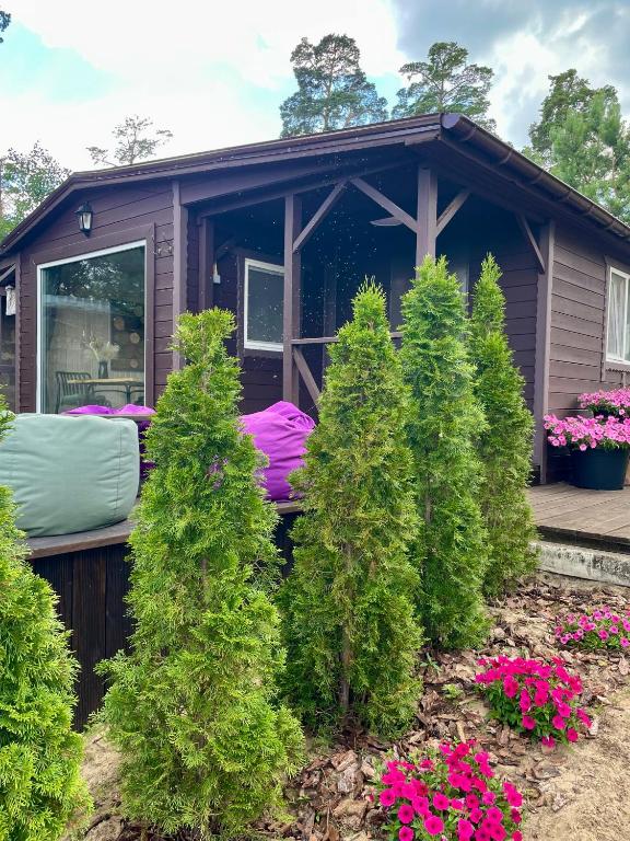 a house with a bed in the front of it at Spokiy in Glebovka