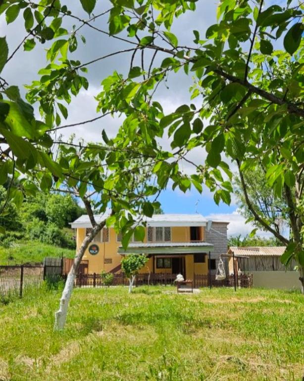 a house in the middle of a field with trees at Rich Garden House in Vanadzor