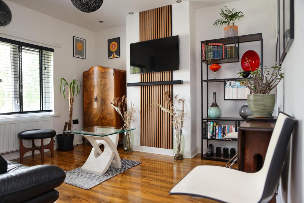 a living room with a couch and a table at Century Apartments Manchester in Dukinfield