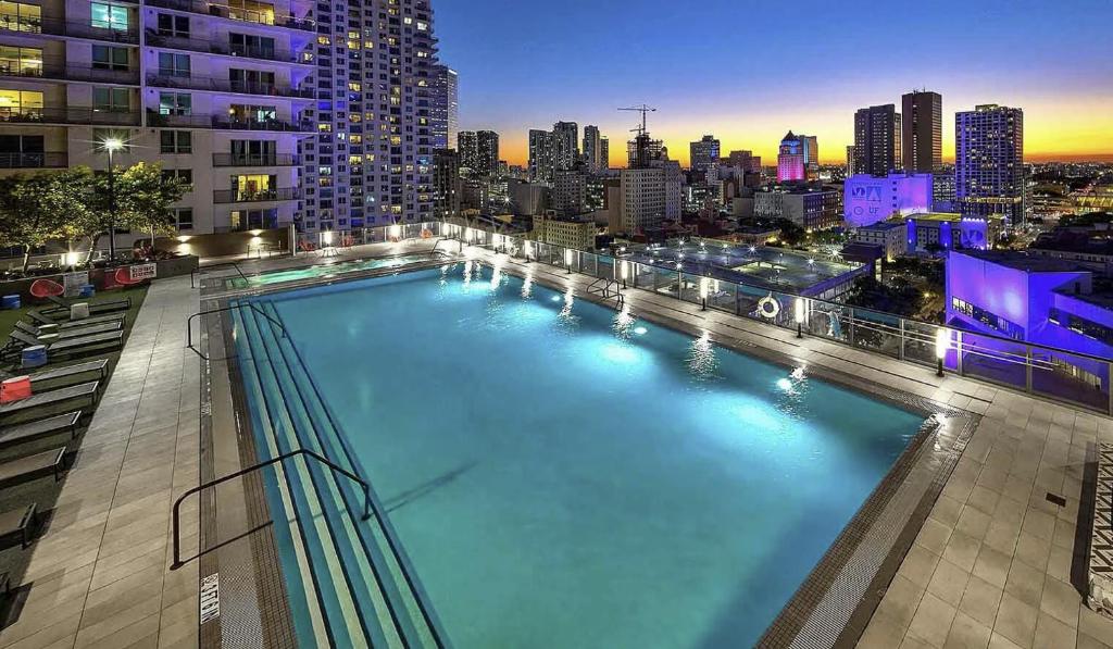 a large swimming pool on top of a building at Miami Downtown Bayside Balcony Studio in Miami