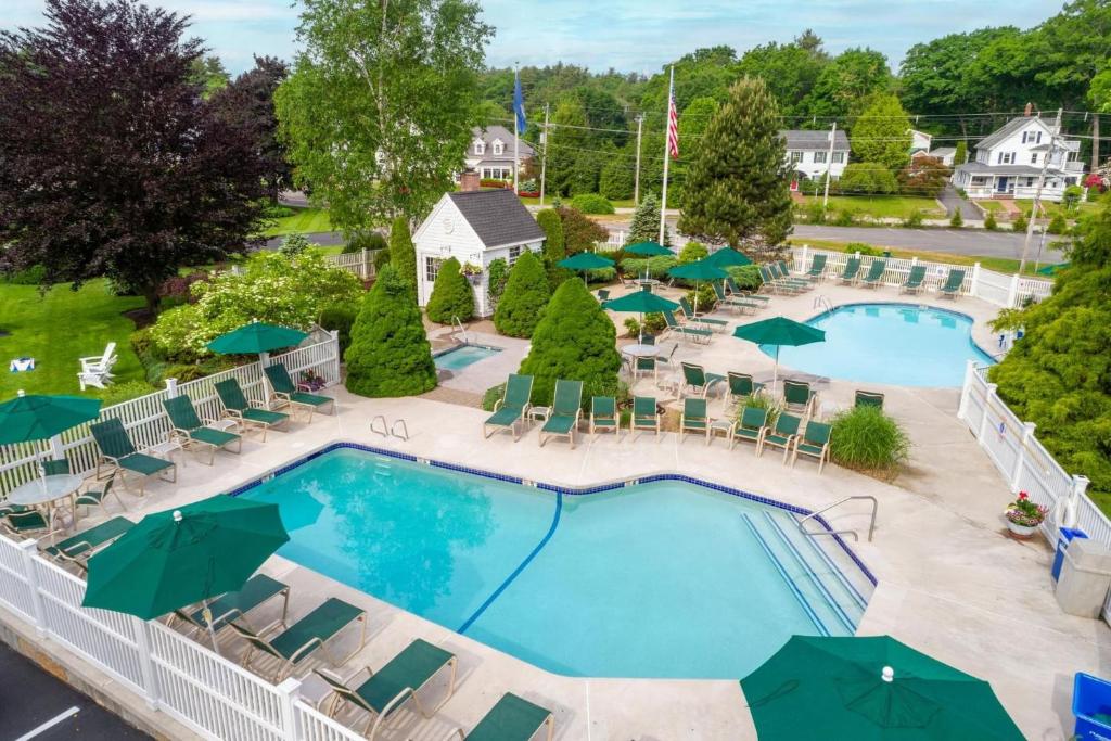 an overhead view of a pool with chairs and umbrellas at Juniper Hill Inn in Ogunquit