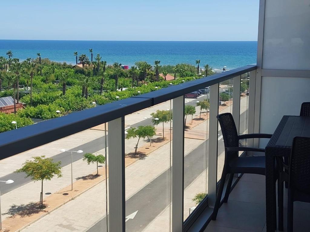 a balcony with a view of a beach and the ocean at Costa Azahar - En Primera Línea in El Borseral