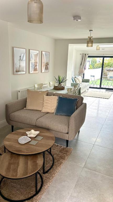 a living room with a couch and a table at Rose Cottage, Killala in Killala