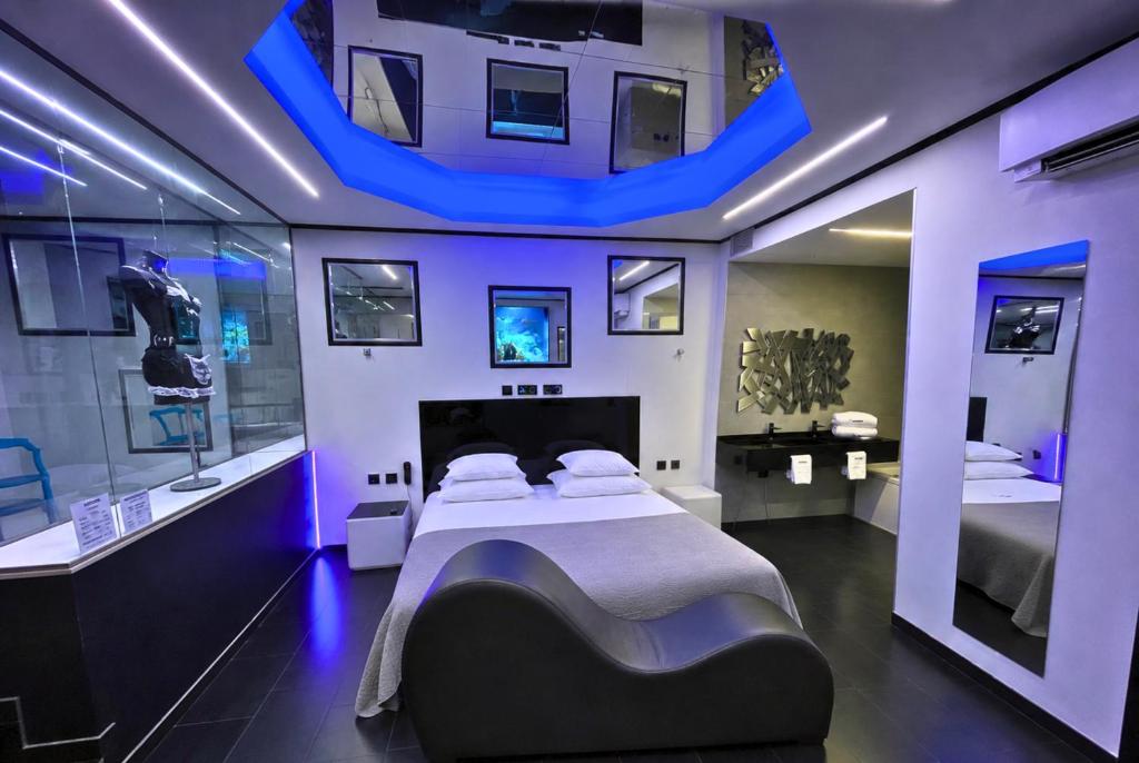a bedroom with a large bed in a room with purple lights at Motel Venus Madrid Norte in Meco