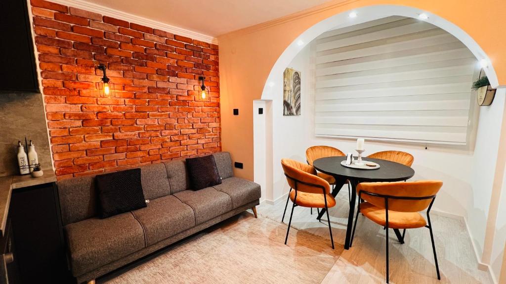 a living room with a couch and a table at Escapist Apartments in Niš