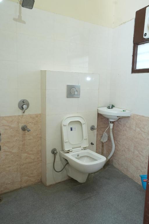 a bathroom with a toilet and a sink at Hotel Hari Sarovar in Kurukshetra
