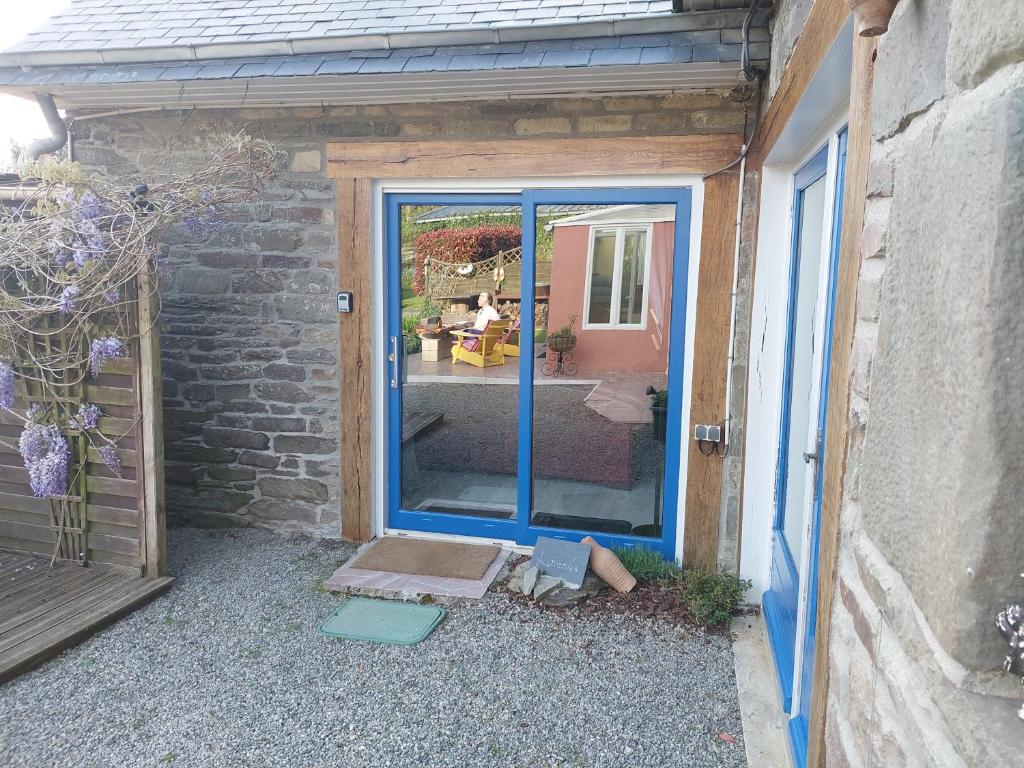 a glass door of a building with a patio at Green Acres Bretagne in Maël-Carhaix